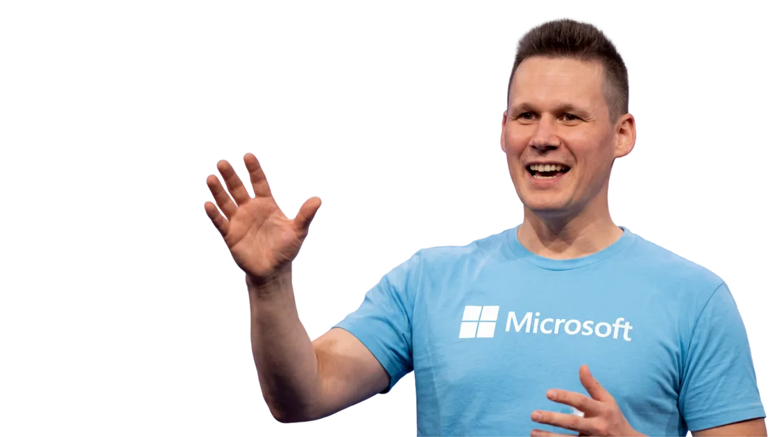 Christopher Nett waving, wearing a Microsoft t-shirt